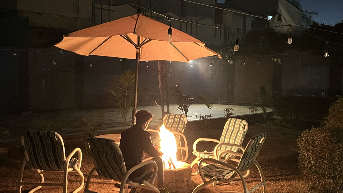 Guest relaxing by the courtyard fire pit